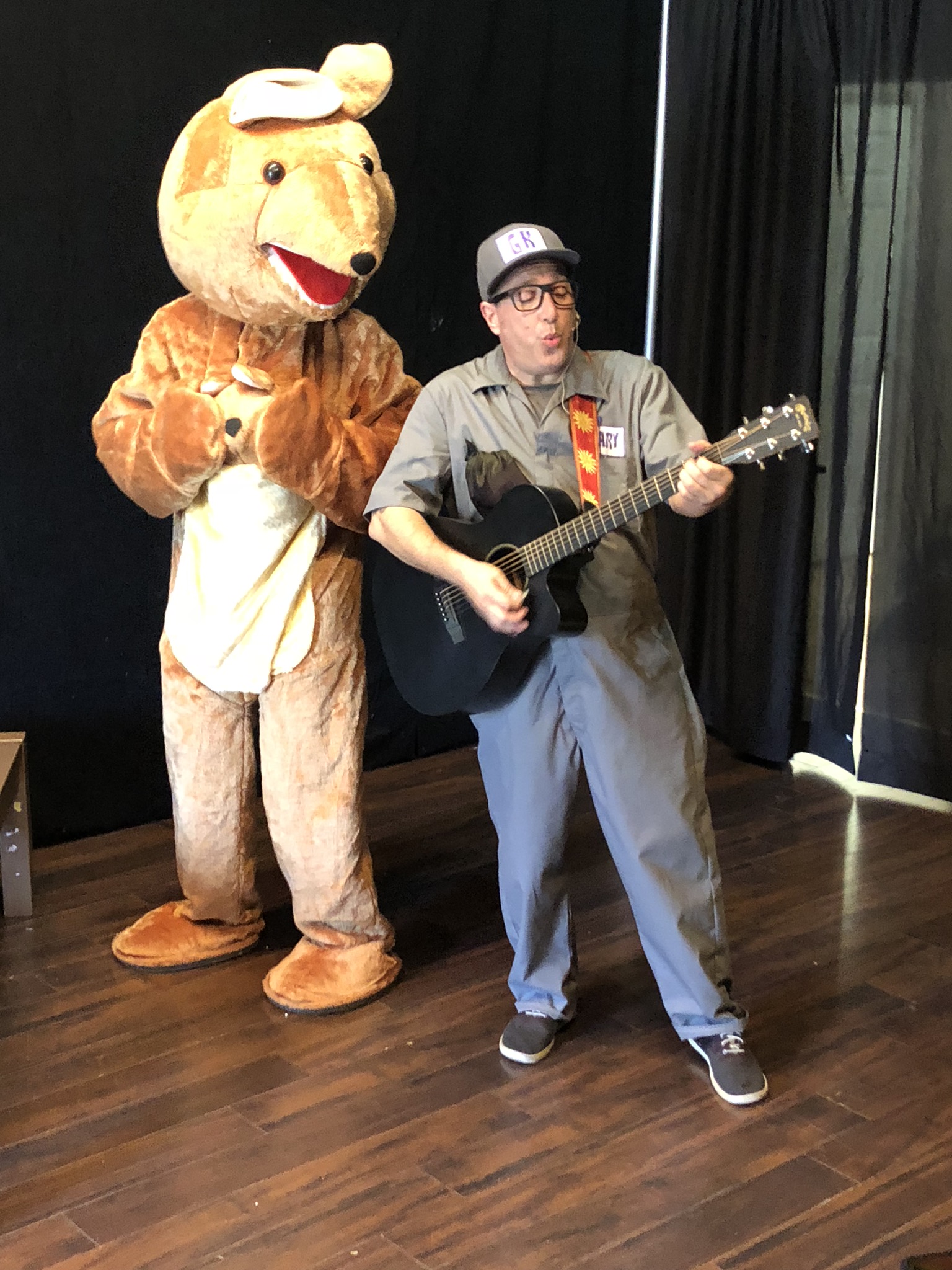Gary Kazoo playing guitar beside Kayla the Kangaroo