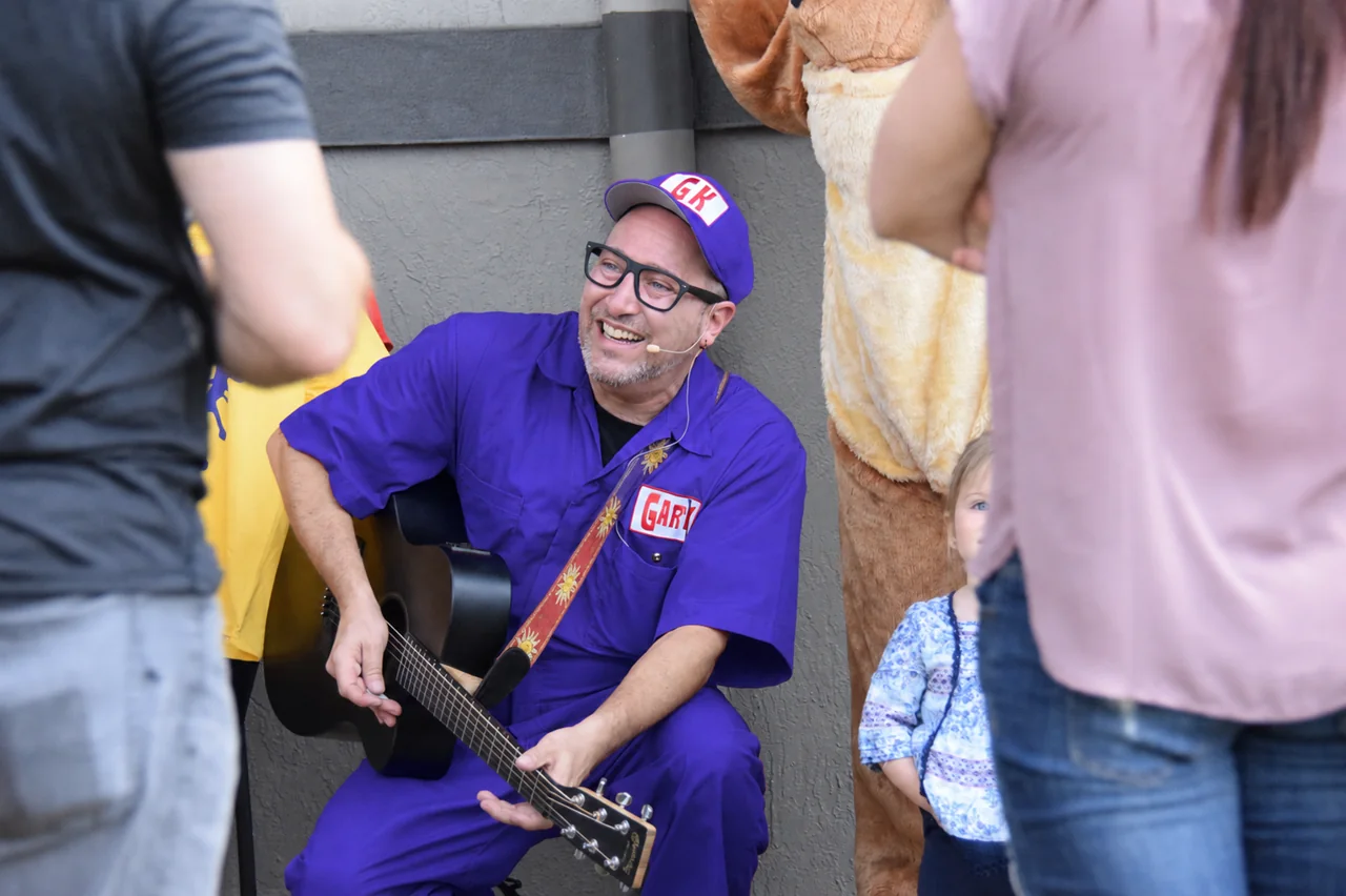 Gary Kazoo smiling with his guitar during a family event